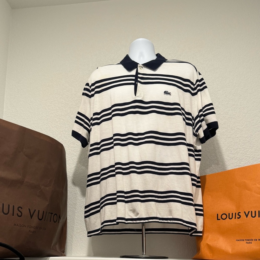 Classic cream Lacoste regular fit polo w/navy  stripes. Size: FR 9/US 4XL.